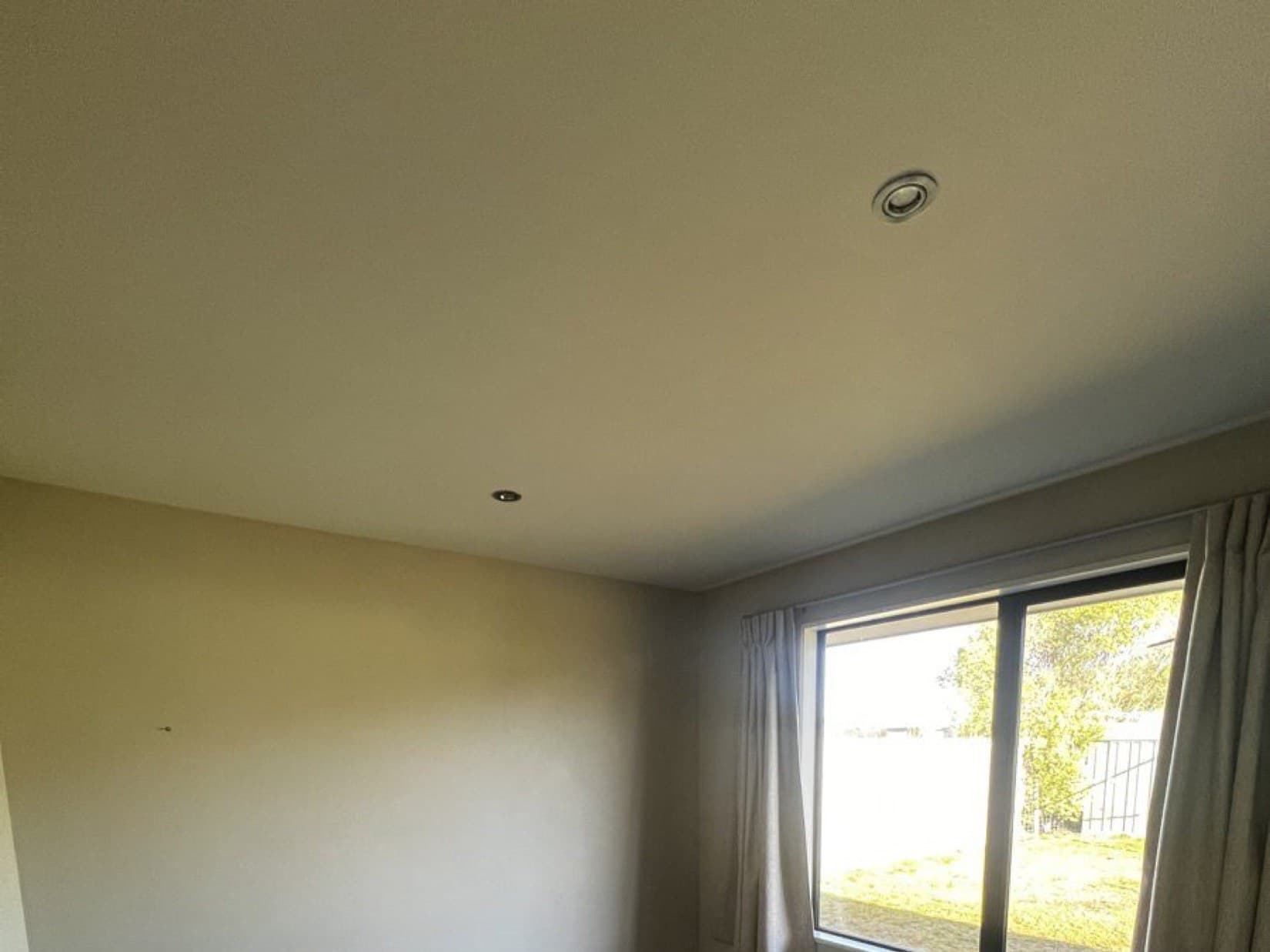 The same bedroom clean, bright and even after washing, sealing and two fresh coats of ceiling paint.