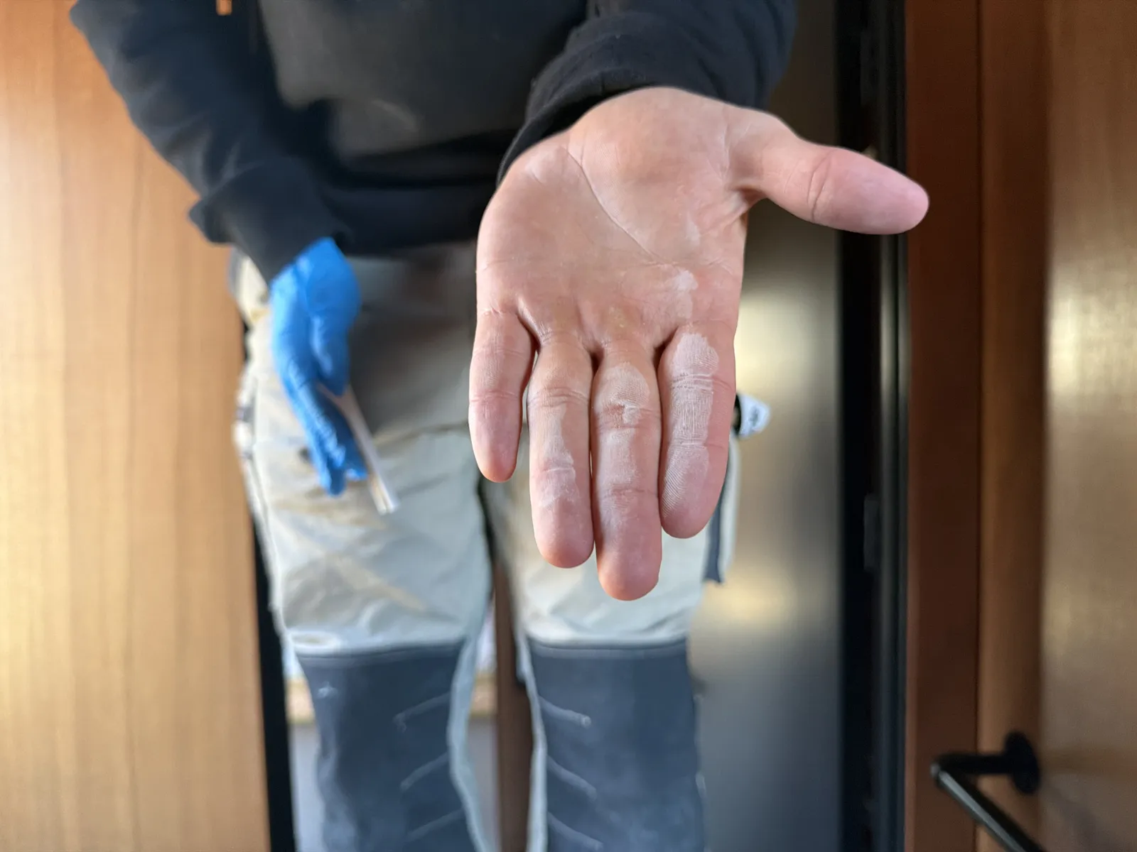 Fine white dust on the palm after wiping the test patch, the sign of a fully cured coating